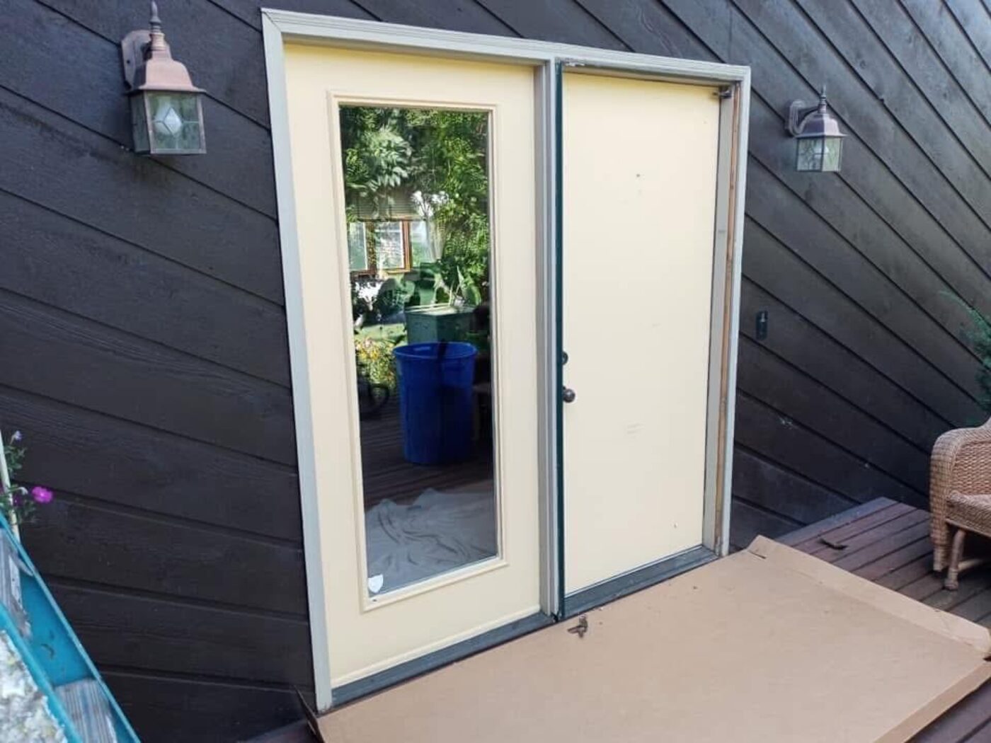 Rear door and frame being fitted on a dark-sided home