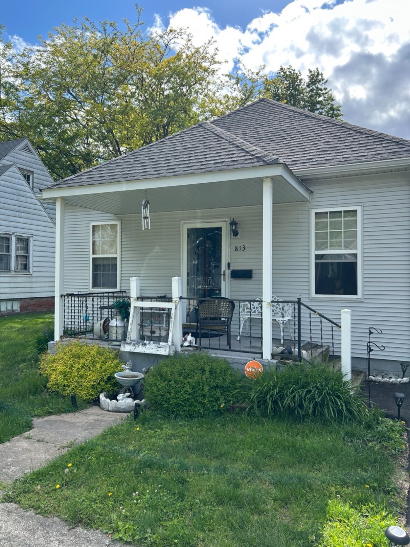 Open front porch with railings before it was closed in and re-sided